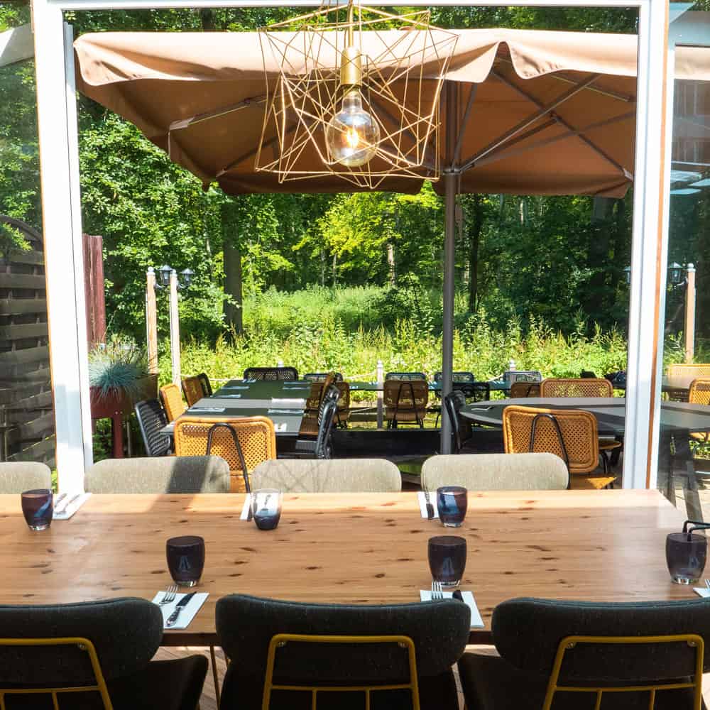 Donato's restaurant offers an inviting outdoor dining area in Den Haag, furnished with comfortable tables and chairs.