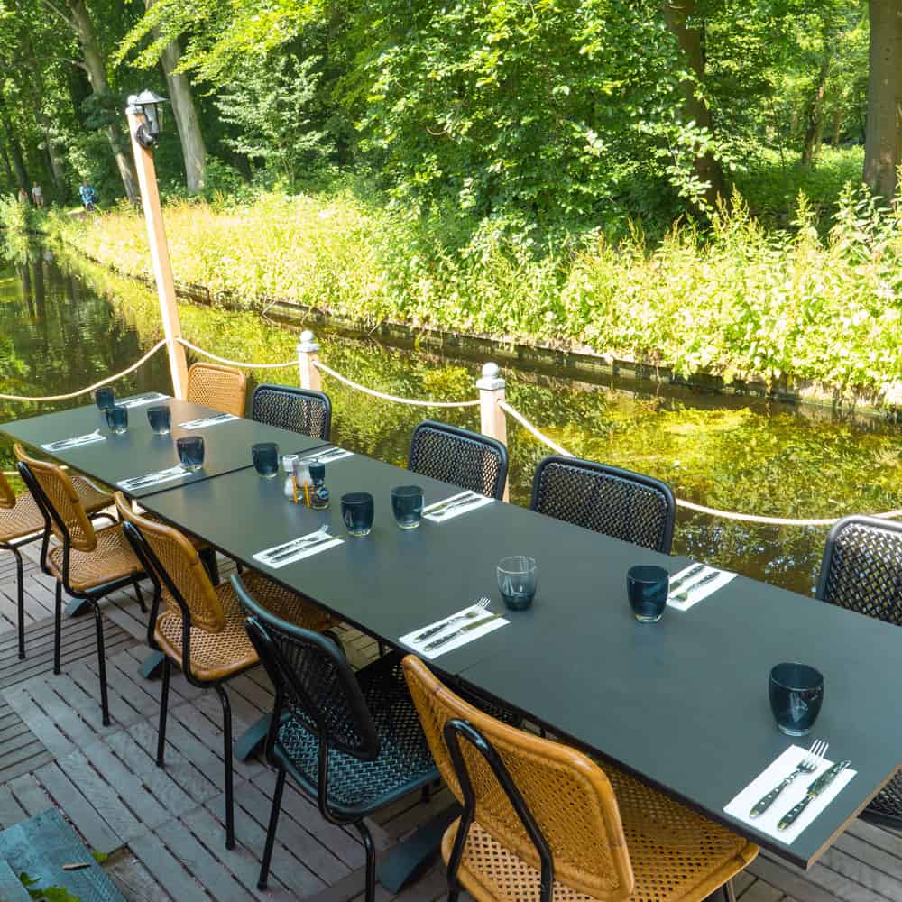 In the beautiful city of Den Haag, guests can enjoy a delightful dining experience at Donato. This popular riverside restaurant features a charming wooden deck adorned with comfortable chairs, allowing patrons to relax and